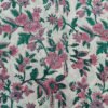 White fabric with dense pink and green floral patterns