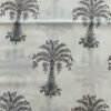 White fabric with pink floral embroidery and green leaves