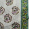 White fabric with dense green floral patterns and border