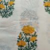 White fabric with yellow flower block print