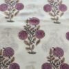 White fabric with purple round flower motifs