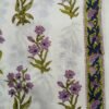 White fabric with teal and pink floral designs