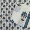 white cotton fabric with blue floral designs